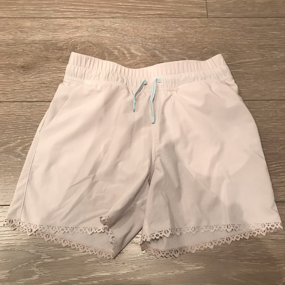 Cream colour Ivivva shorts.